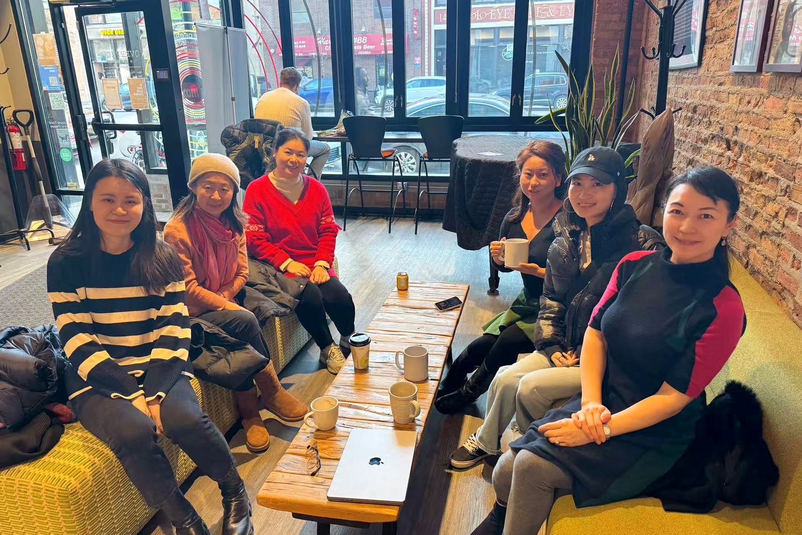 AAWA women gathered around a coffee shop table for conversation